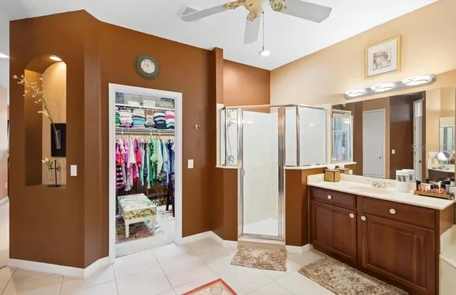 a spacious bathroom with a mirror sink and shower