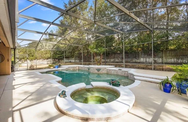 a view of a swimming pool with a patio