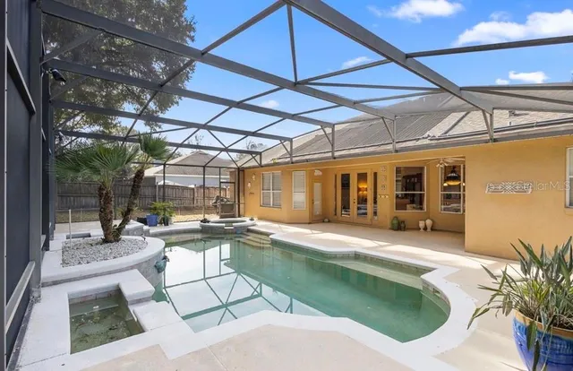 a swimming pool with outdoor seating and yard