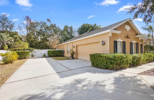 a view of a white house with a yard
