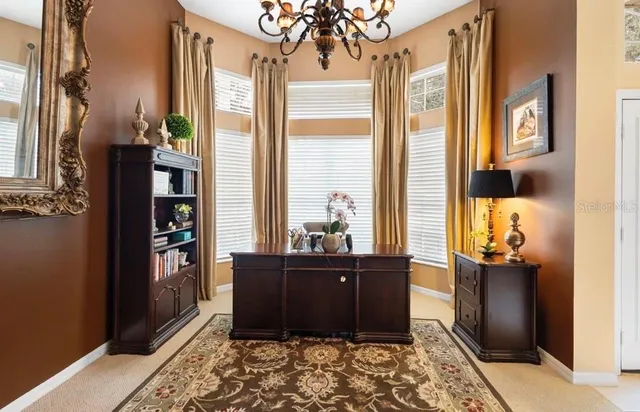 a room with wooden floor and a chandelier