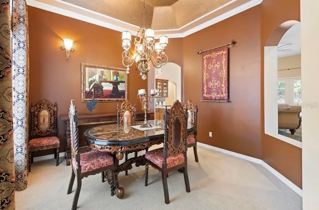a view of a dining room with furniture and chandelier