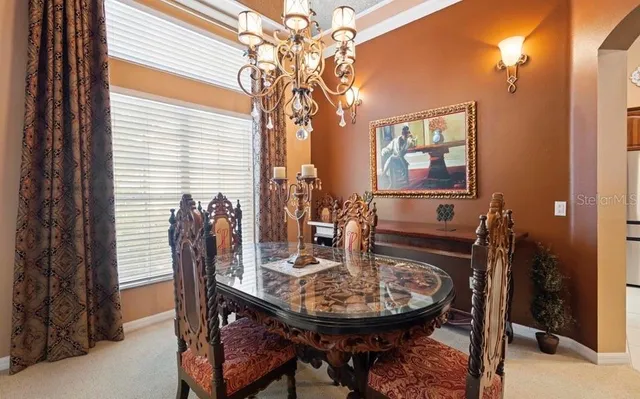 a view of a dining room with furniture and chandelier