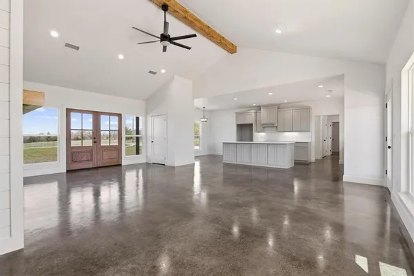 a view of an empty room with glass door