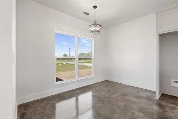 a kitchen with white cabinets and sink