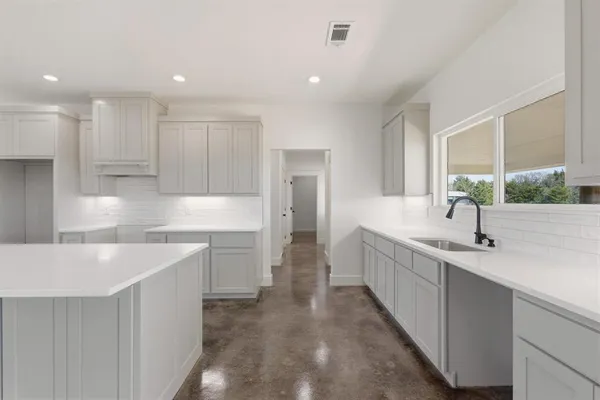 a kitchen with counter top space sink and refrigerator