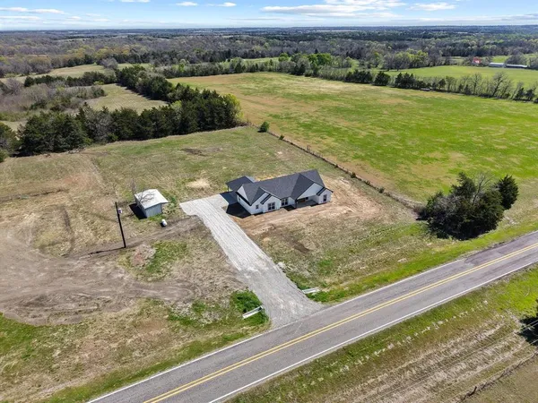 an aerial view of a houses with outdoor space