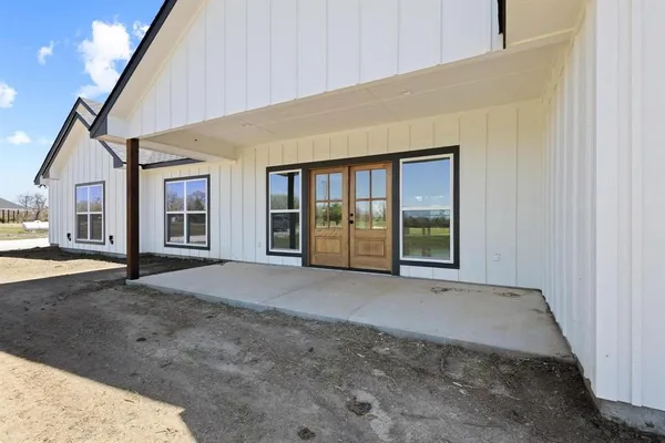 a view of empty room with wooden floor and windows