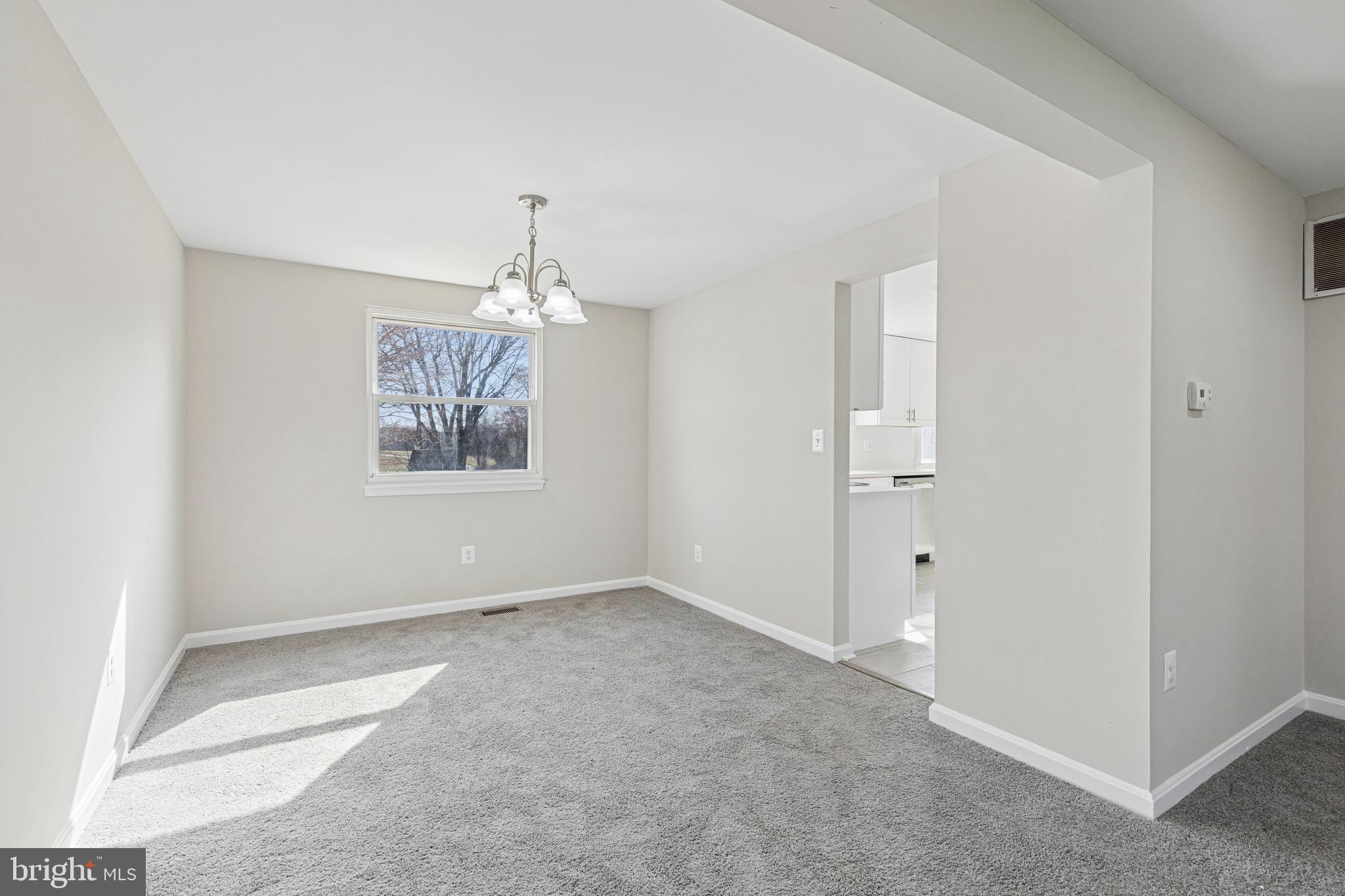 7451 Oakland Mills Road Columbia, MD 21046 - Photo 24 of 83 an empty room with windows and chandelier