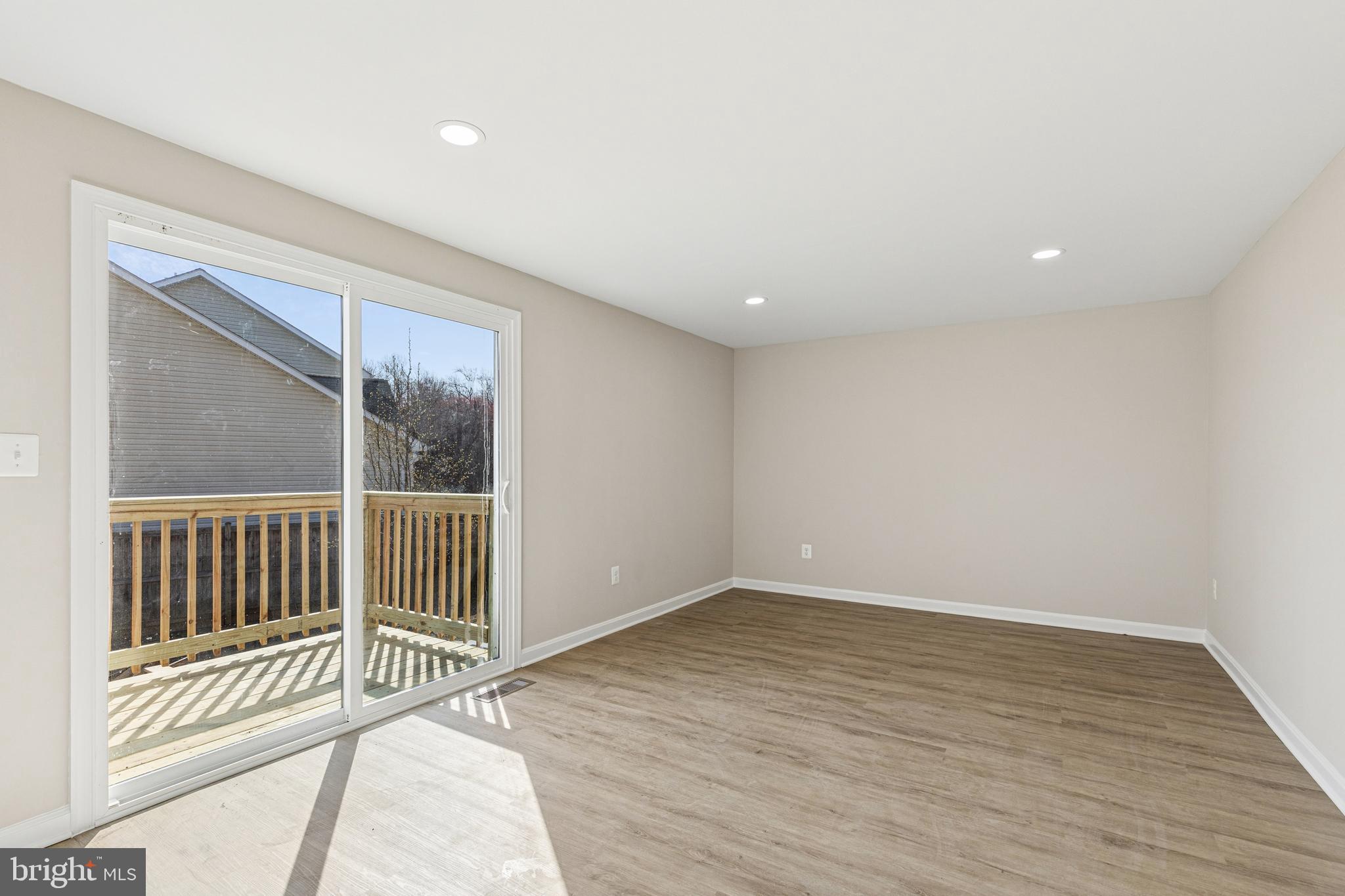 7451 Oakland Mills Road Columbia, MD 21046 - Photo 33 of 83 an empty room with wooden floor and windows