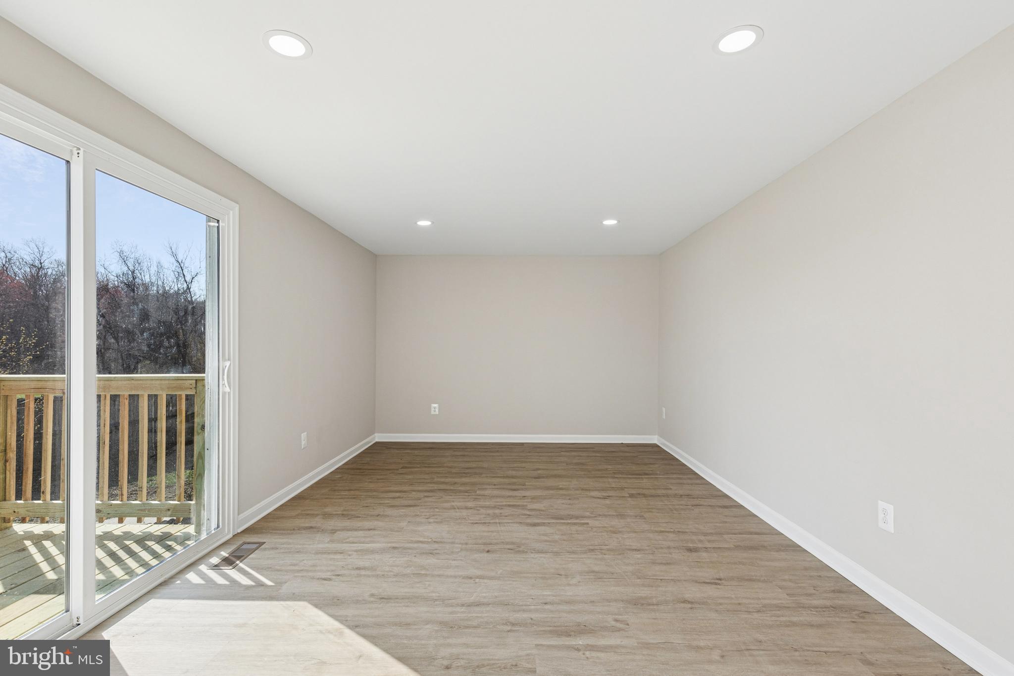 7451 Oakland Mills Road Columbia, MD 21046 - Photo 34 of 83 an empty room with wooden floor and windows