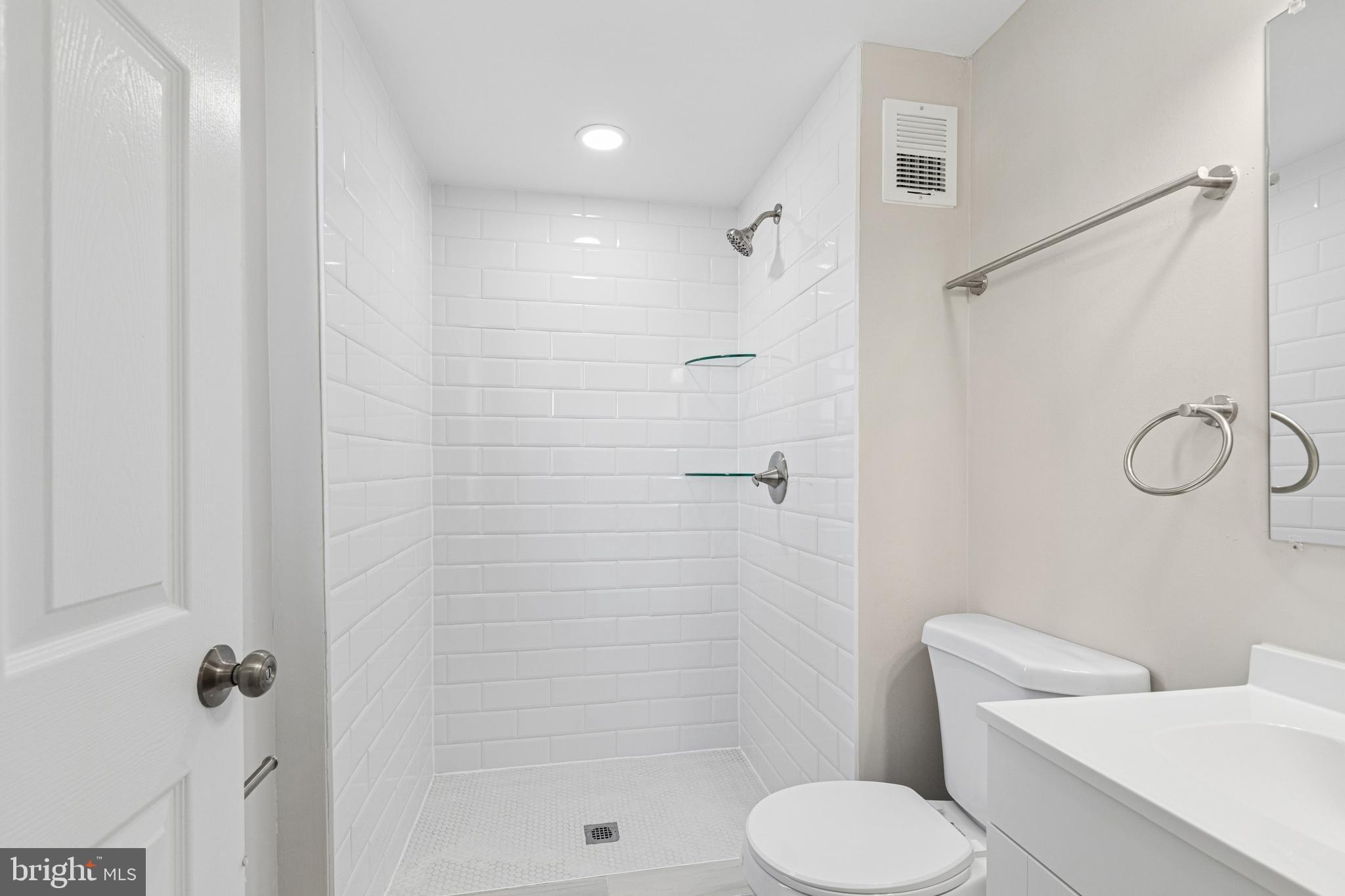 7451 Oakland Mills Road Columbia, MD 21046 - Photo 61 of 83 a bathroom with a toilet sink and shower