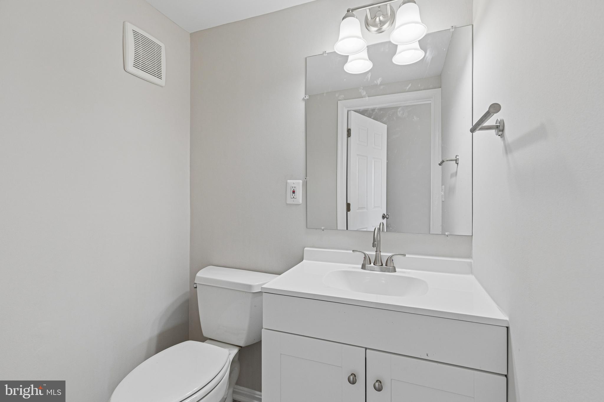 7451 Oakland Mills Road Columbia, MD 21046 - Photo 80 of 83 a bathroom with a sink a toilet and a mirror