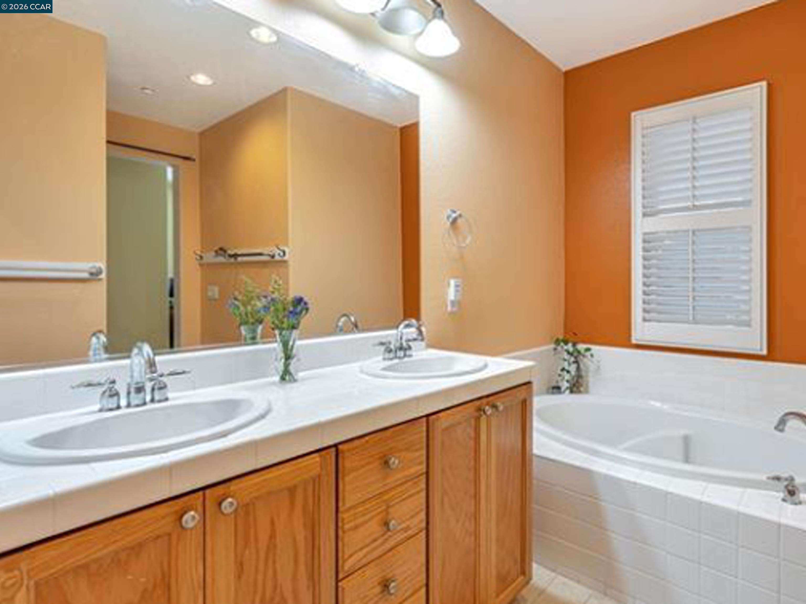 2036 Serra Lane Hercules, CA 94547 - Photo 16 of 50 a bathroom with a granite countertop sink mirror and a bathtub