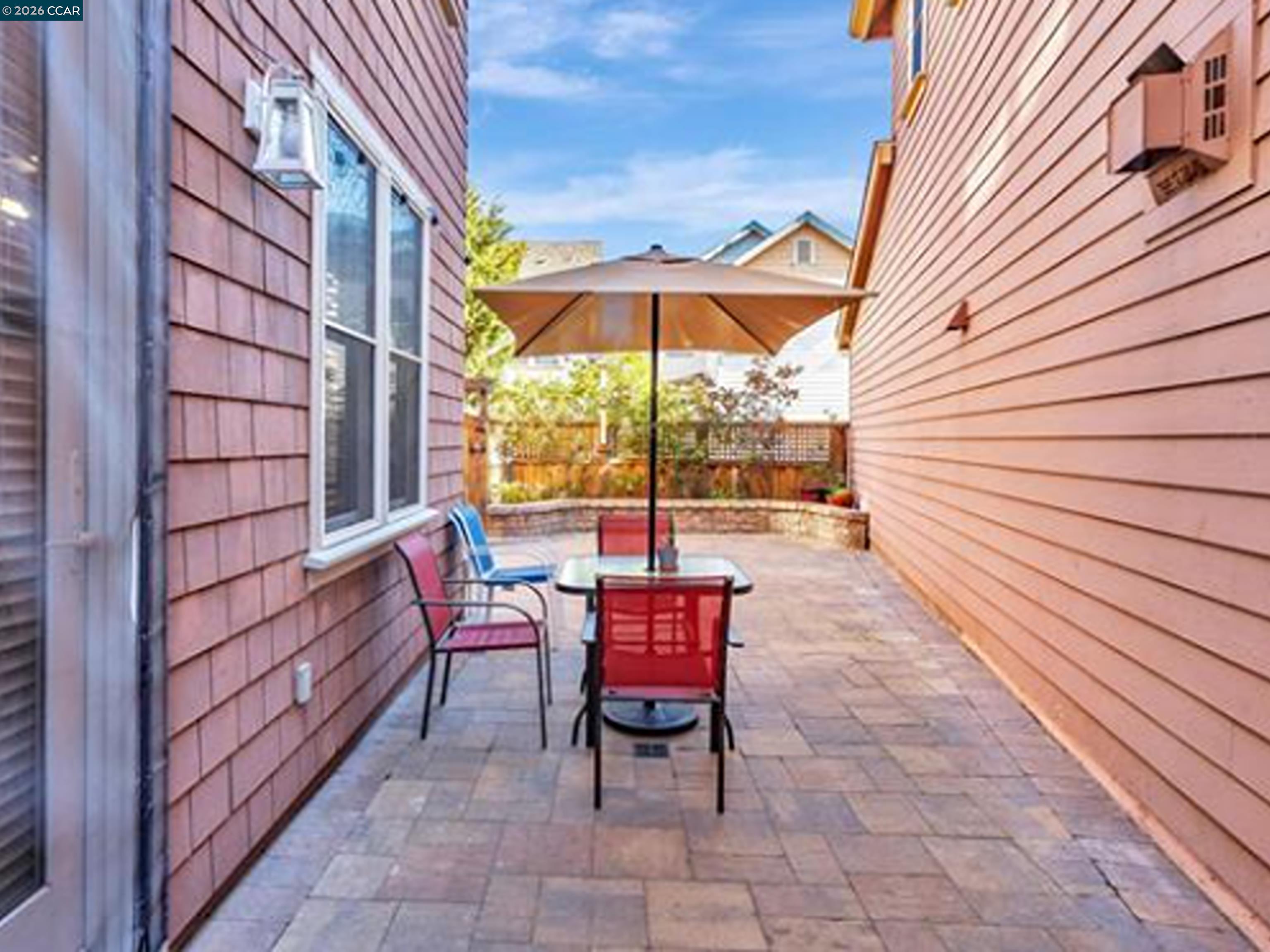 2036 Serra Lane Hercules, CA 94547 - Photo 23 of 50 a view of a patio with a table and chairs under an umbrella