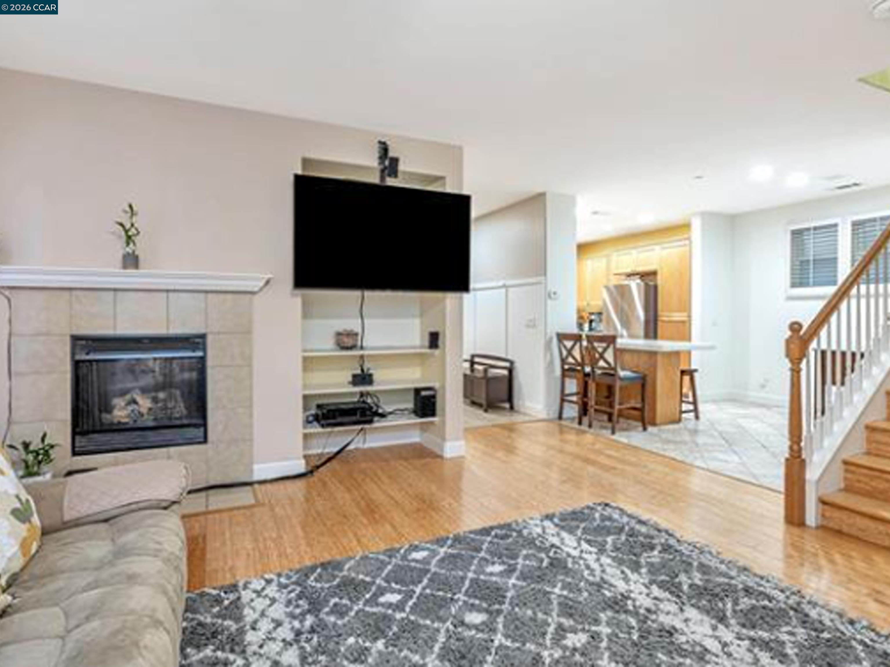 2036 Serra Lane Hercules, CA 94547 - Photo 31 of 50 a living room with furniture a flat screen tv and a fireplace