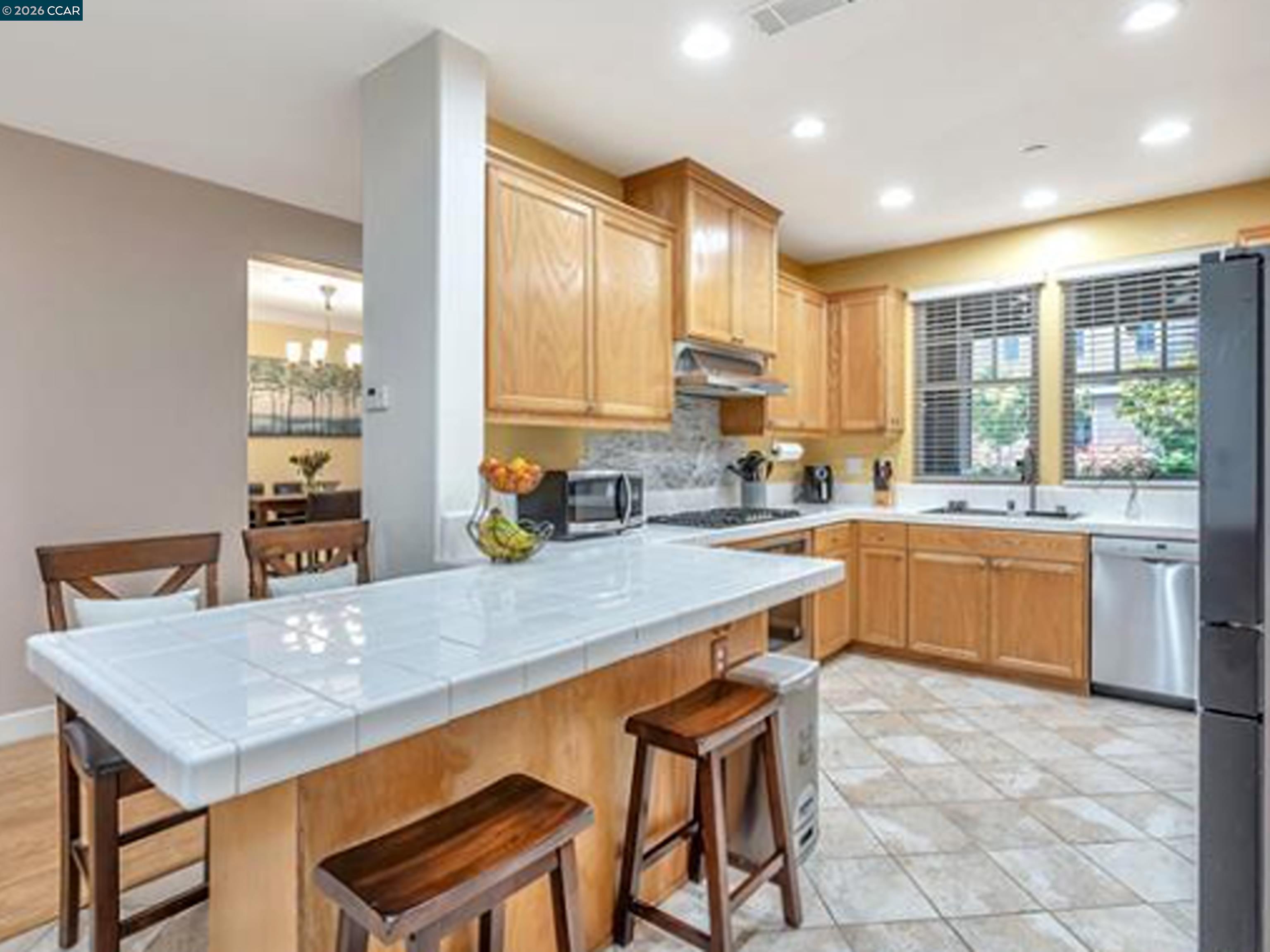 2036 Serra Lane Hercules, CA 94547 - Photo 34 of 50 a kitchen with a table chairs sink and cabinets