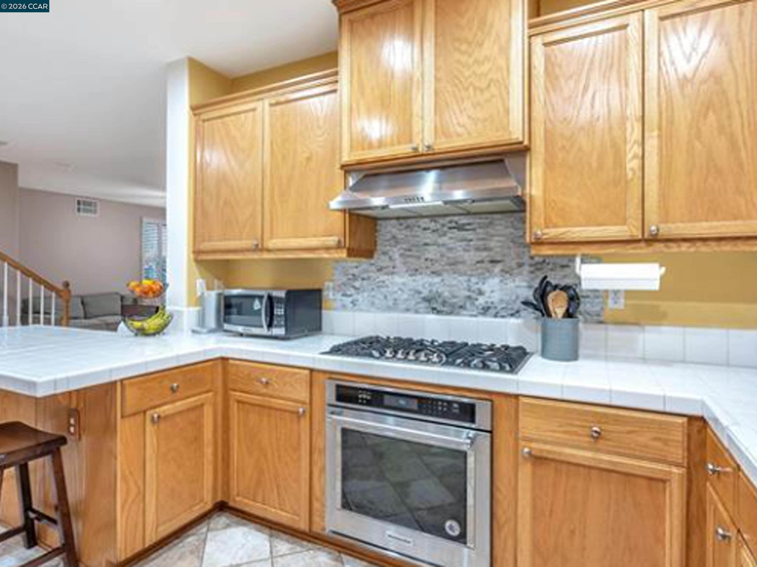 2036 Serra Lane Hercules, CA 94547 - Photo 37 of 50 a kitchen with stainless steel appliances granite countertop white cabinets and a stove top oven
