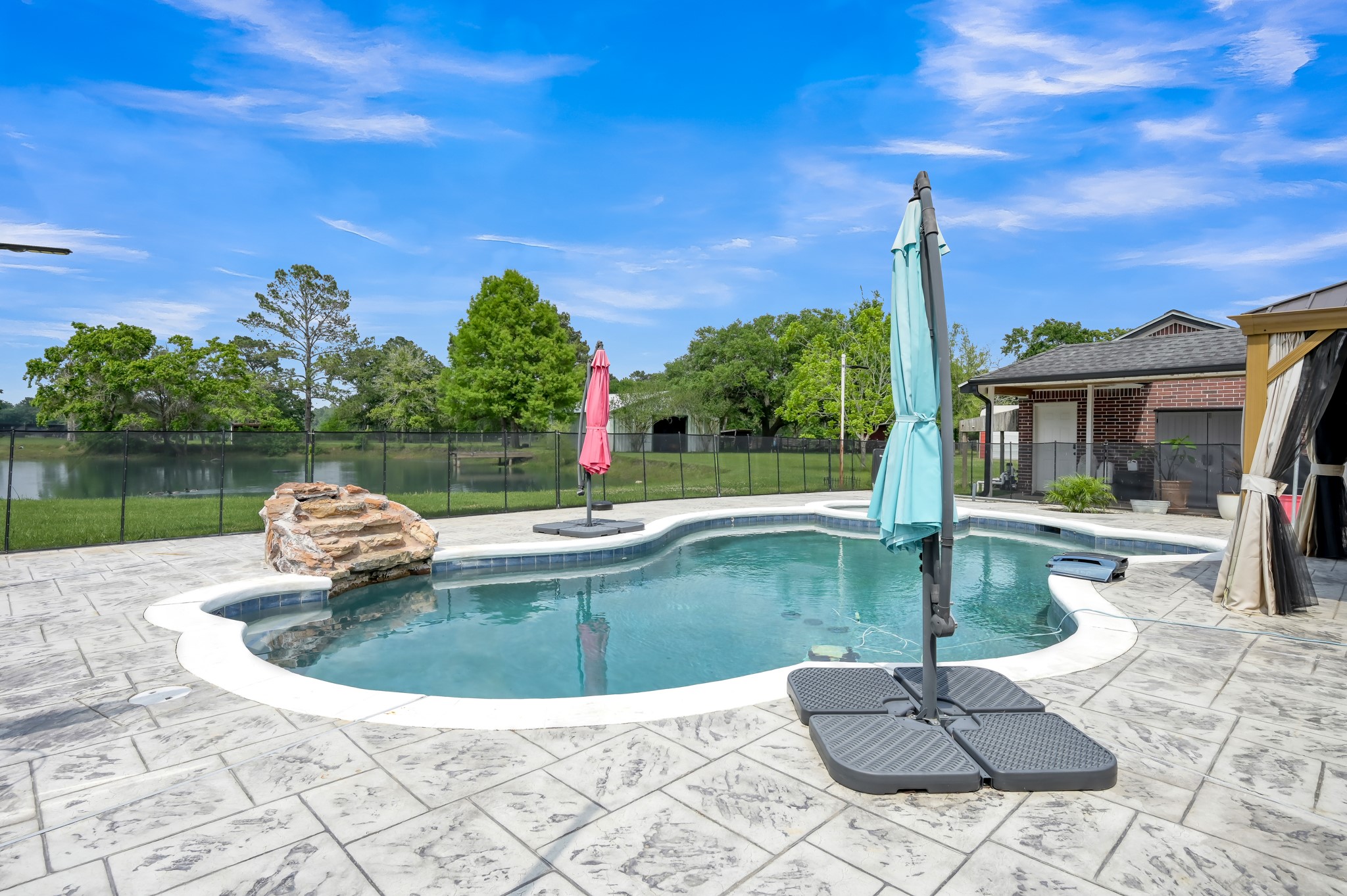 251 Petty Road Waller, TX 77484 - Photo 22 of 25 a view of a swimming pool with a patio