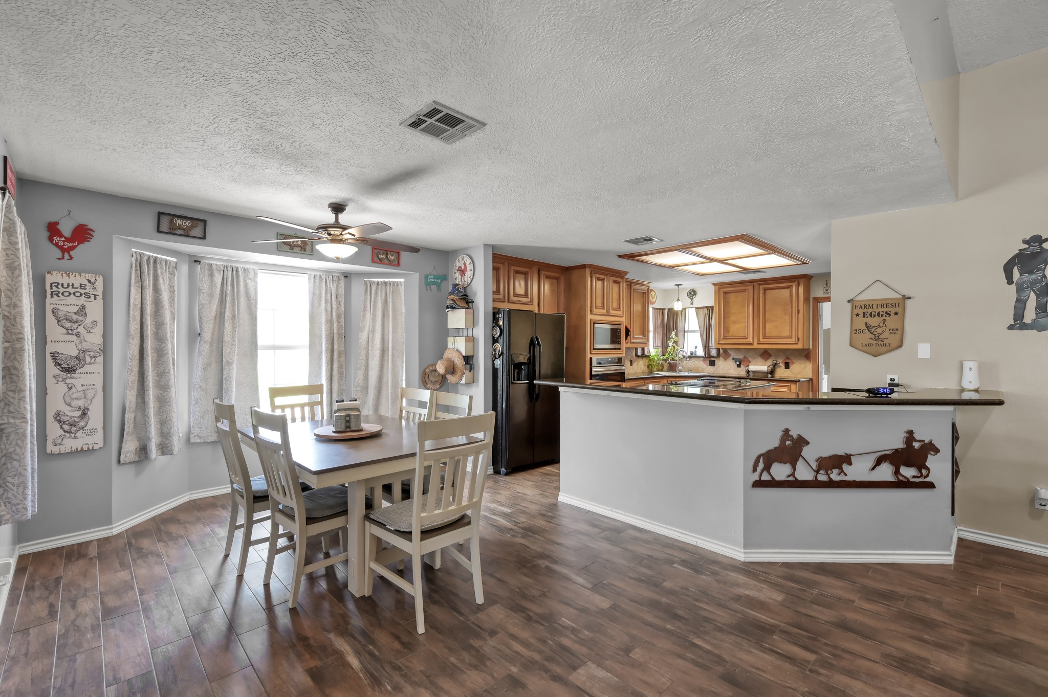 251 Petty Road Waller, TX 77484 - Photo 10 of 25 a view of a dining room with furniture and wooden floor