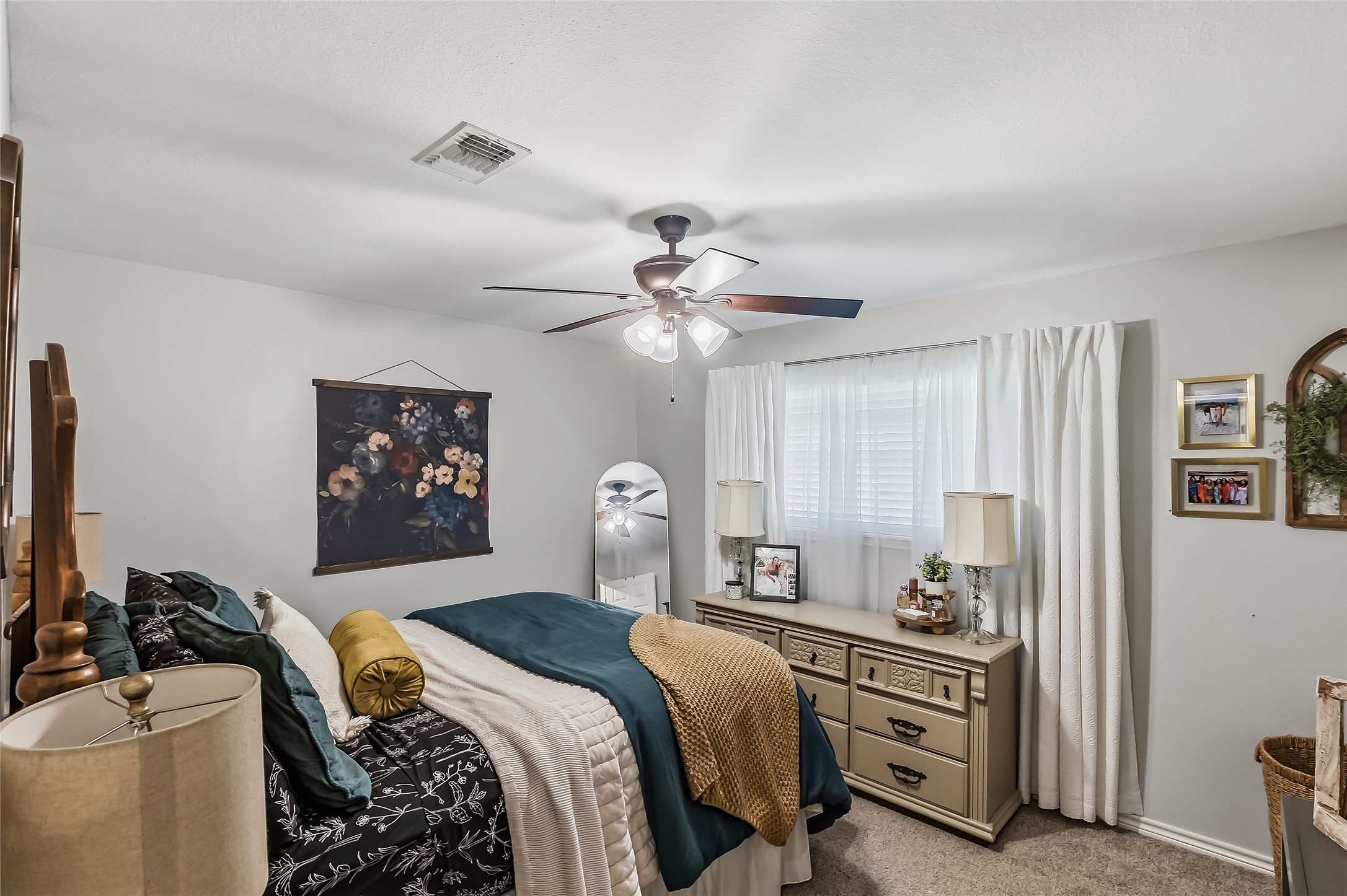 906 Standley Road Madisonville, TX 77864 - Photo 23 of 40 a bedroom with a bed and a chandelier