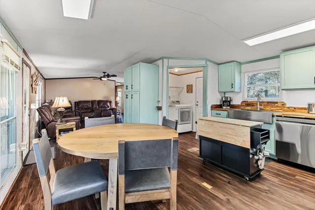 a dining room with furniture and wooden floor