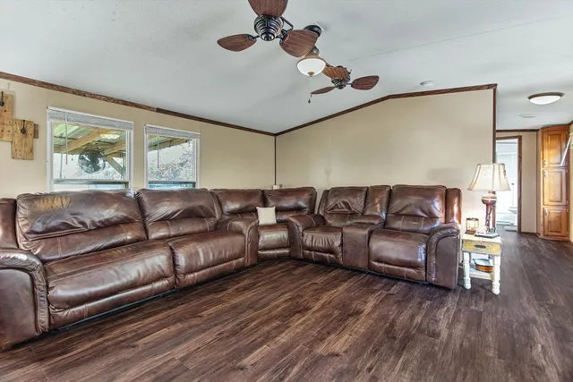 a living room with furniture flat screen tv and wooden floor