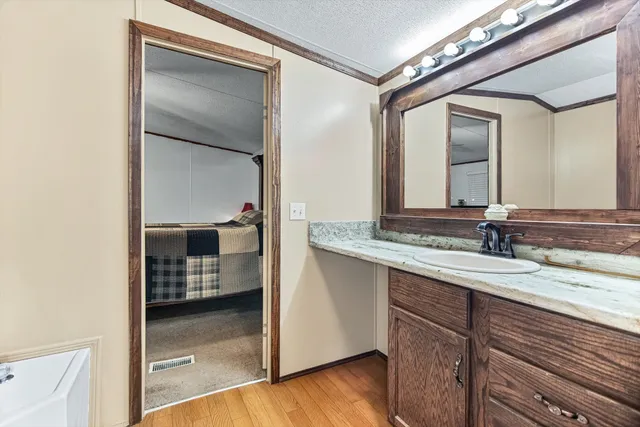 a bathroom with a double vanity sink and mirror