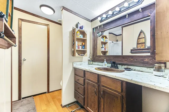 a en suite bathroom with a sink a mirror and a shower