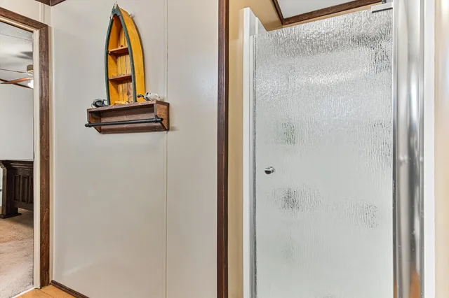 a bed room with a bed and a ceiling fan