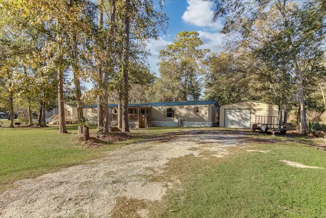 a view of a yard with a house and large trees