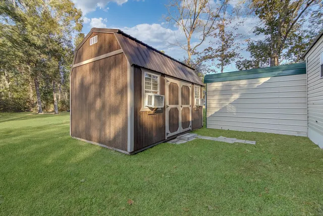 a backyard of a house with table and chairs