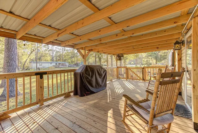 a view of a patio with a table chairs and wooden floor