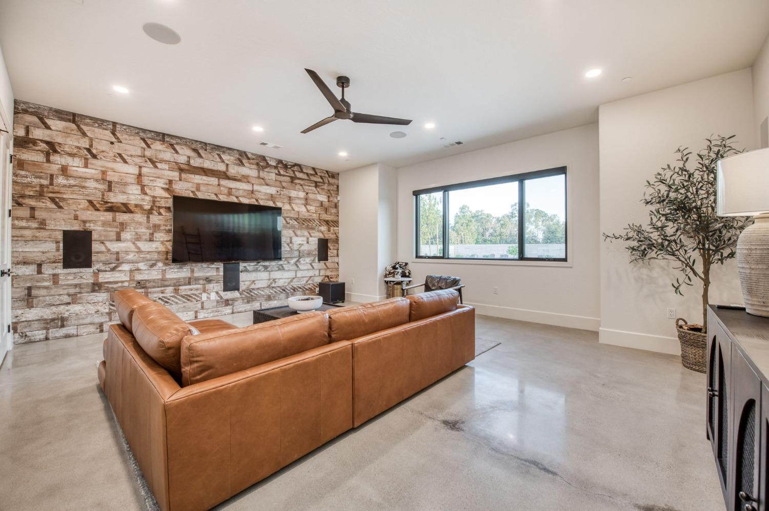 3895 East Reno Avenue Clovis, CA 93619 - Photo 21 of 67 a living room with furniture and a flat screen tv