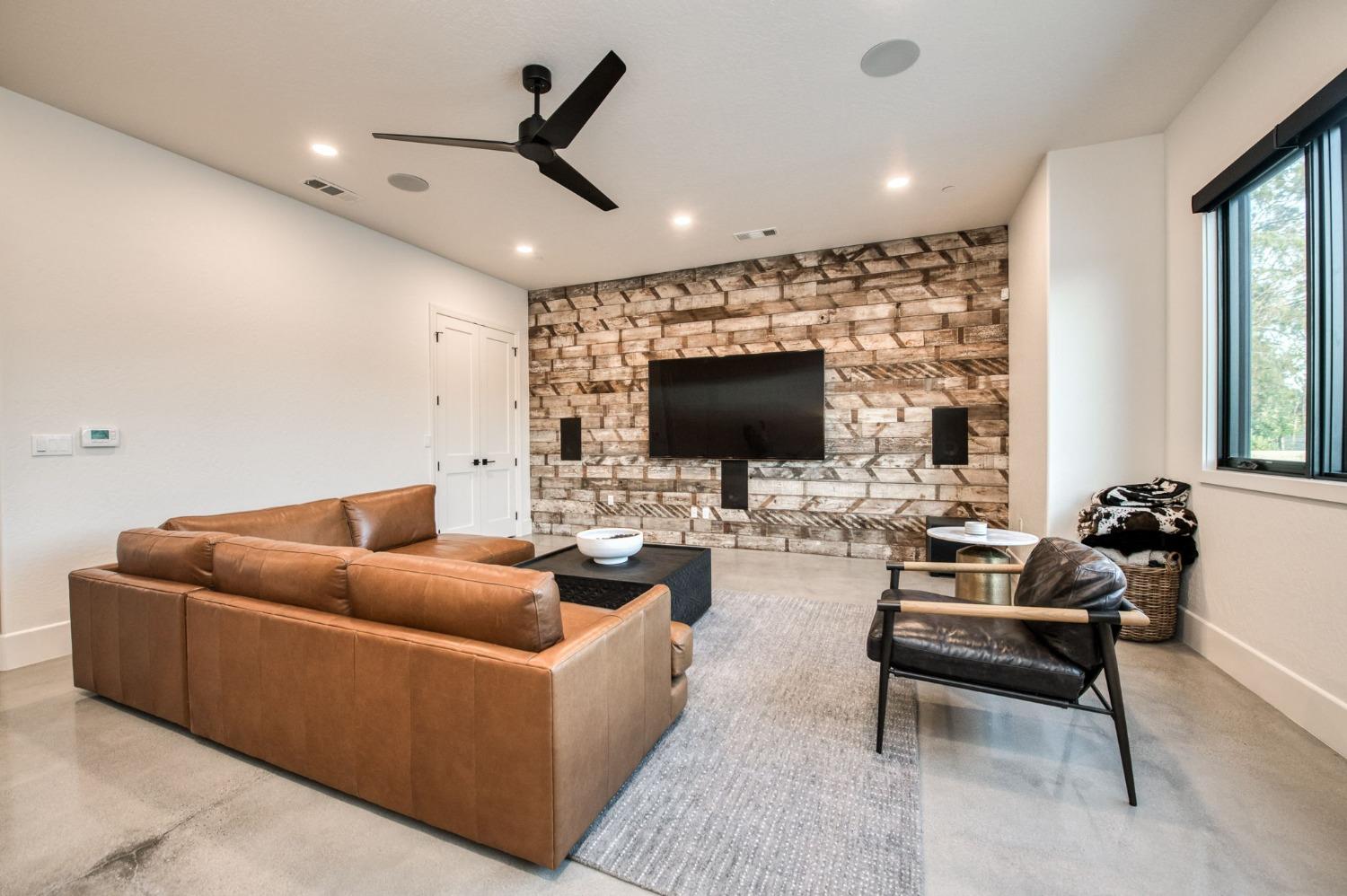 3895 East Reno Avenue Clovis, CA 93619 - Photo 22 of 67 a living room with furniture and a flat screen tv