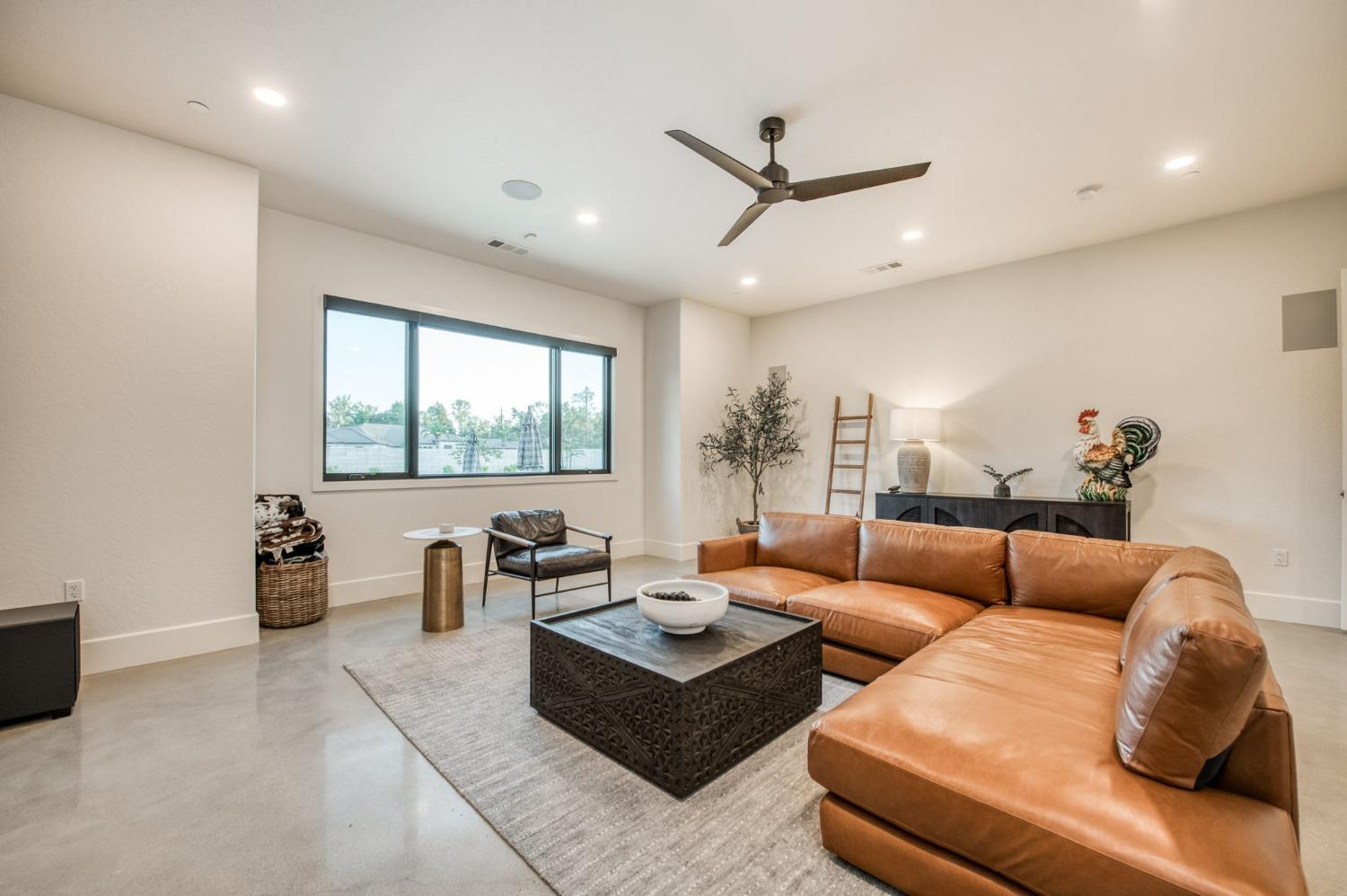 3895 East Reno Avenue Clovis, CA 93619 - Photo 23 of 67 a living room with furniture and a large window