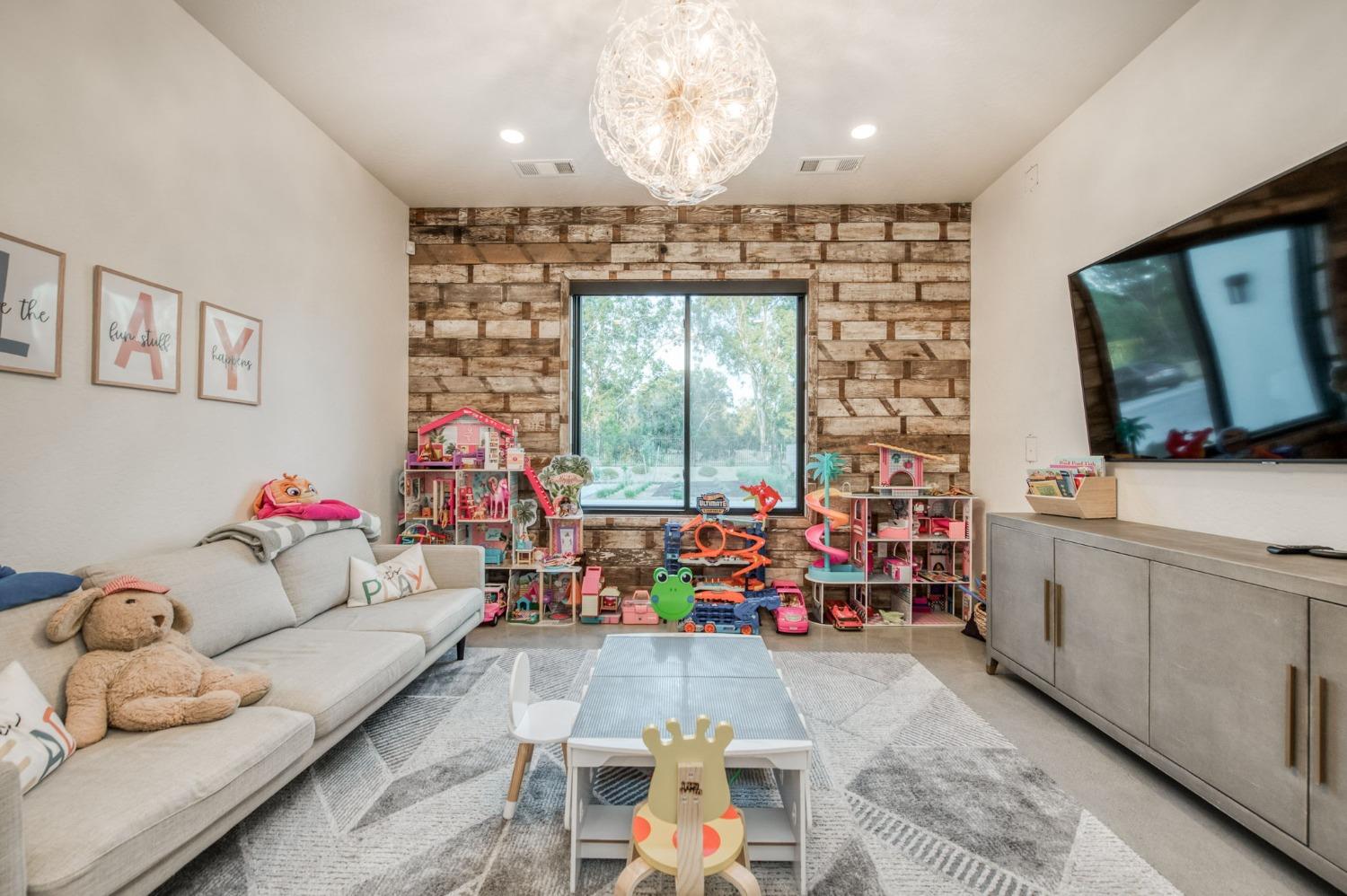 3895 East Reno Avenue Clovis, CA 93619 - Photo 24 of 67 a living room with furniture and a flat screen tv