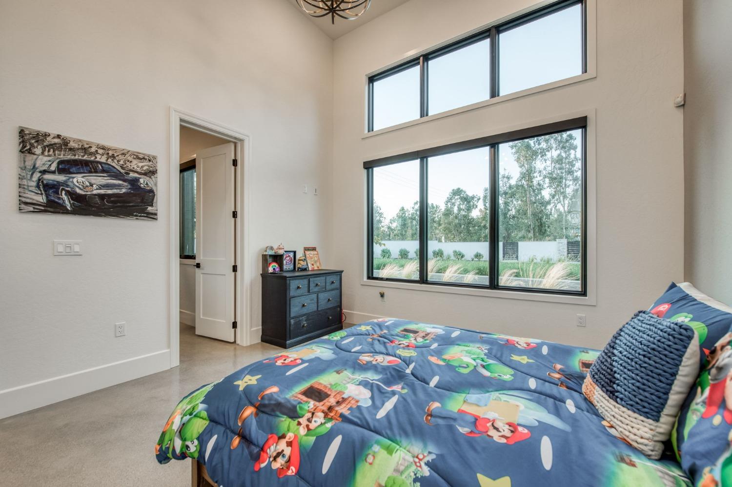 3895 East Reno Avenue Clovis, CA 93619 - Photo 30 of 67 a bedroom with a bed and a window