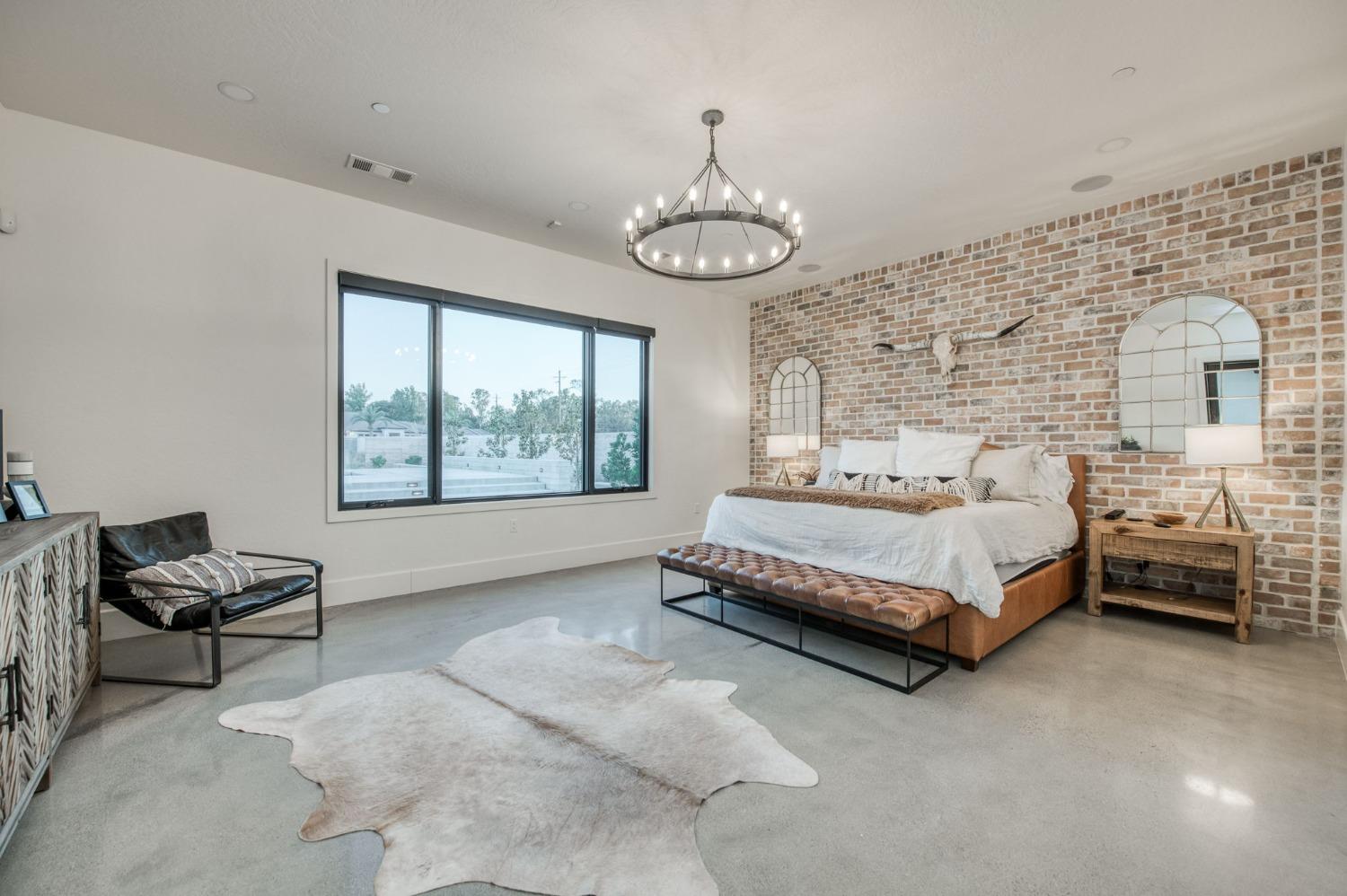 3895 East Reno Avenue Clovis, CA 93619 - Photo 35 of 67 a spacious bedroom with a bed and a window