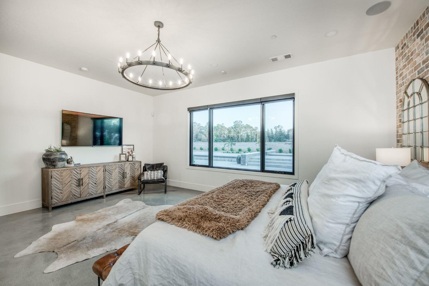 3895 East Reno Avenue Clovis, CA 93619 - Photo 36 of 67 a bedroom with a bed and a flat screen tv