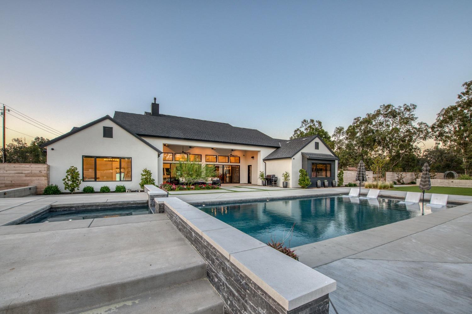 3895 East Reno Avenue Clovis, CA 93619 - Photo 47 of 67 a view of a house with pool and a yard