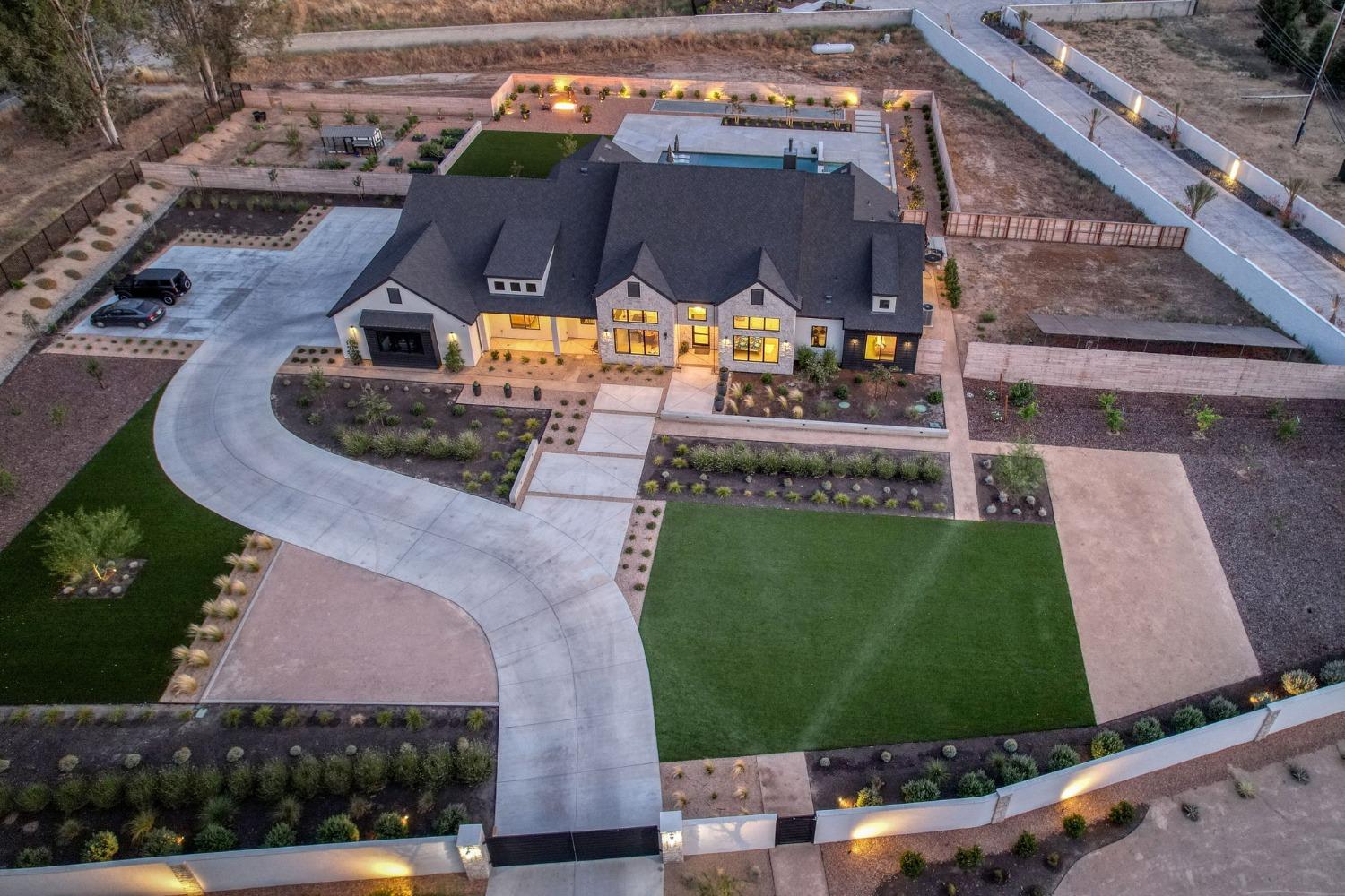 3895 East Reno Avenue Clovis, CA 93619 - Photo 54 of 67 an aerial view of a house with a garden and lake view