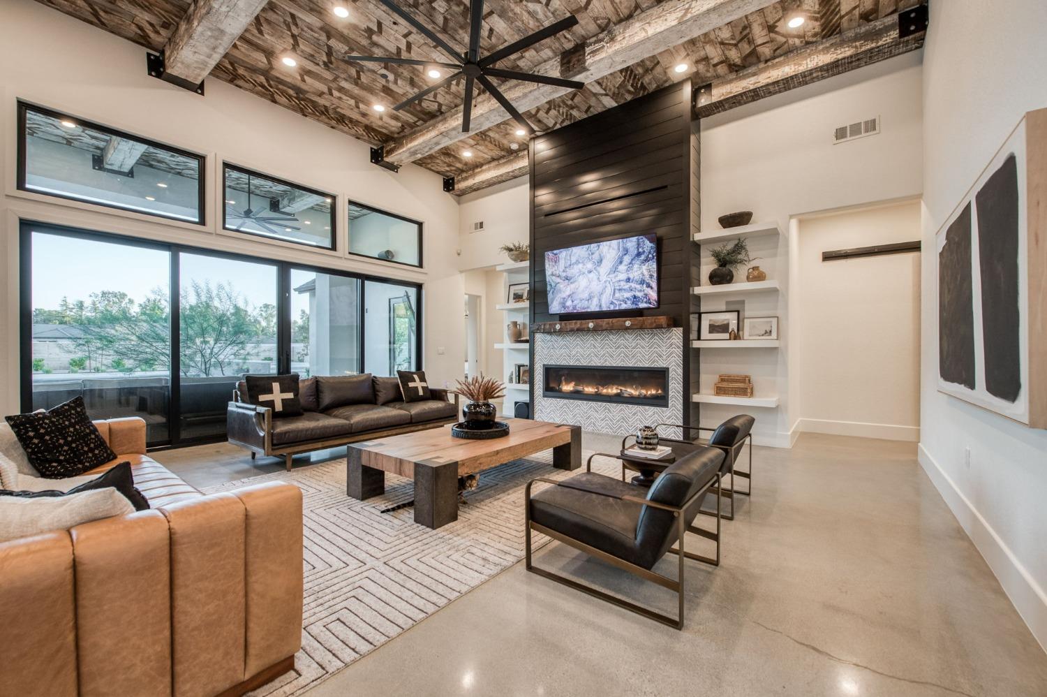3895 East Reno Avenue Clovis, CA 93619 - Photo 7 of 67 a living room with fireplace furniture and a flat screen tv