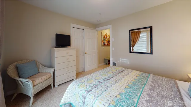 a bedroom with a bed and a television