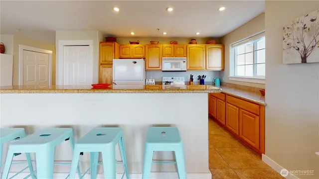 a kitchen with stainless steel appliances granite countertop a sink and cabinets