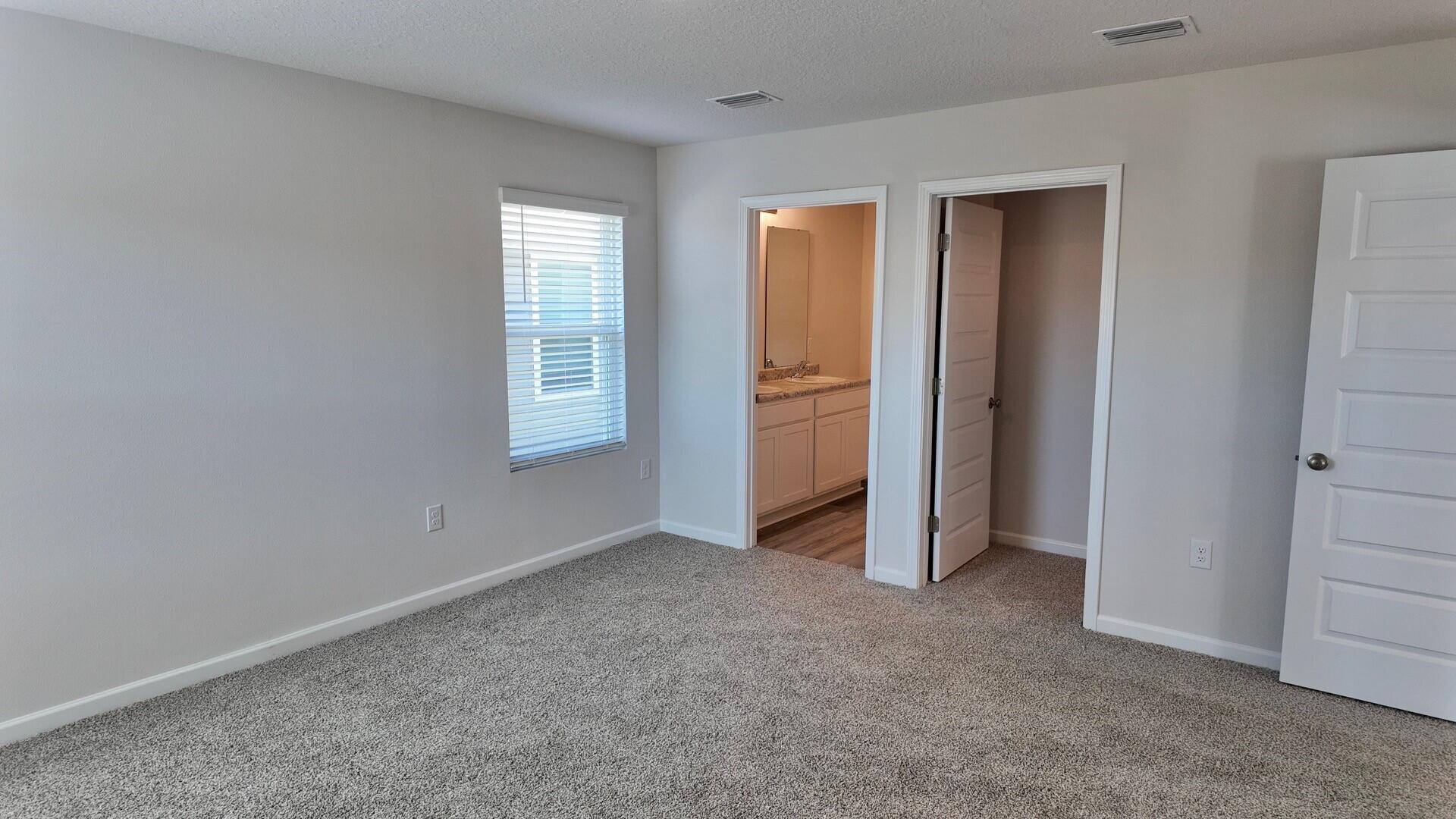 6356 Firefly Drive Milton, FL 32583 - Photo 16 of 44 an empty room with windows and closet