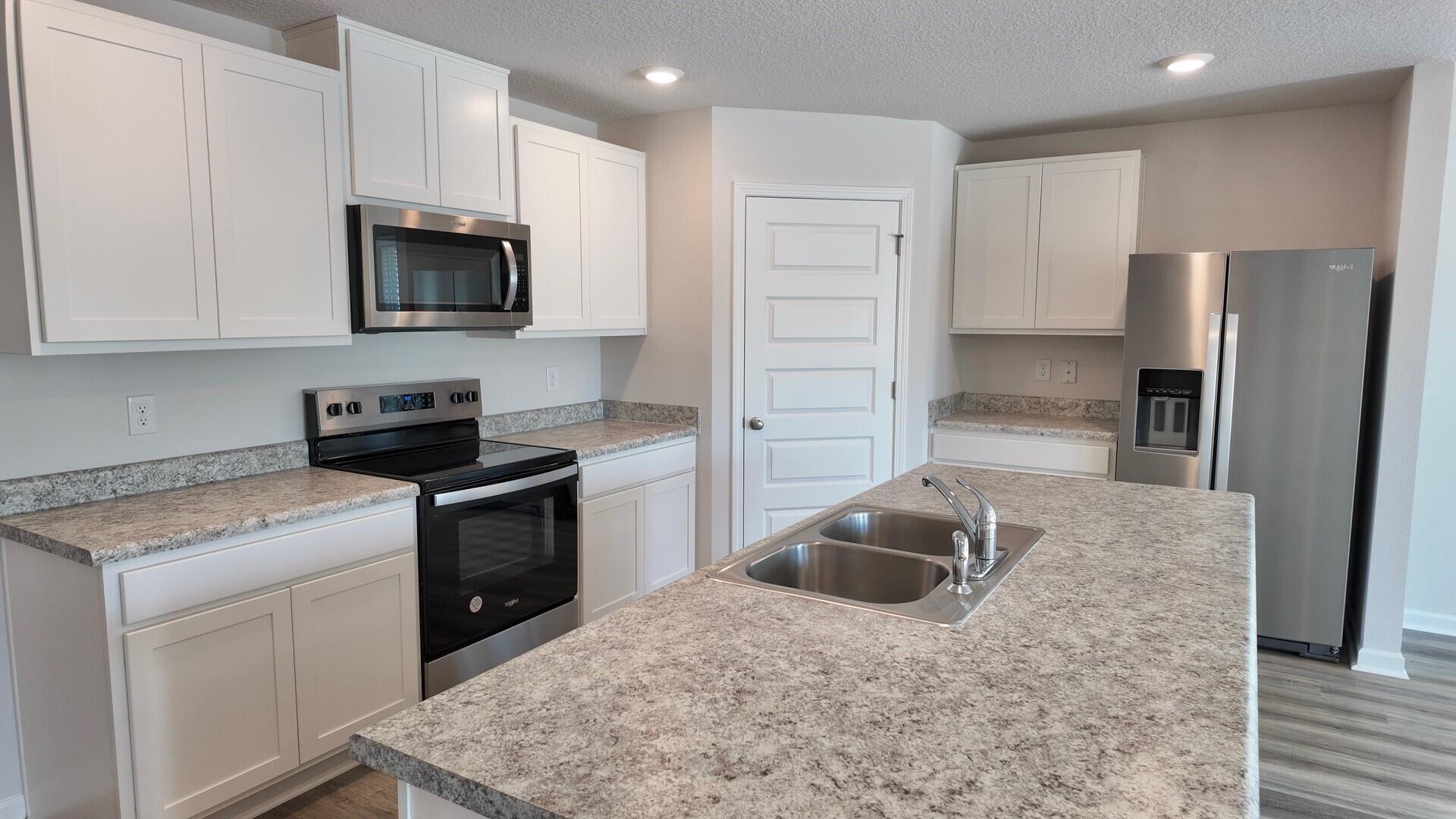 6356 Firefly Drive Milton, FL 32583 - Photo 2 of 44 a kitchen with a sink stove and refrigerator