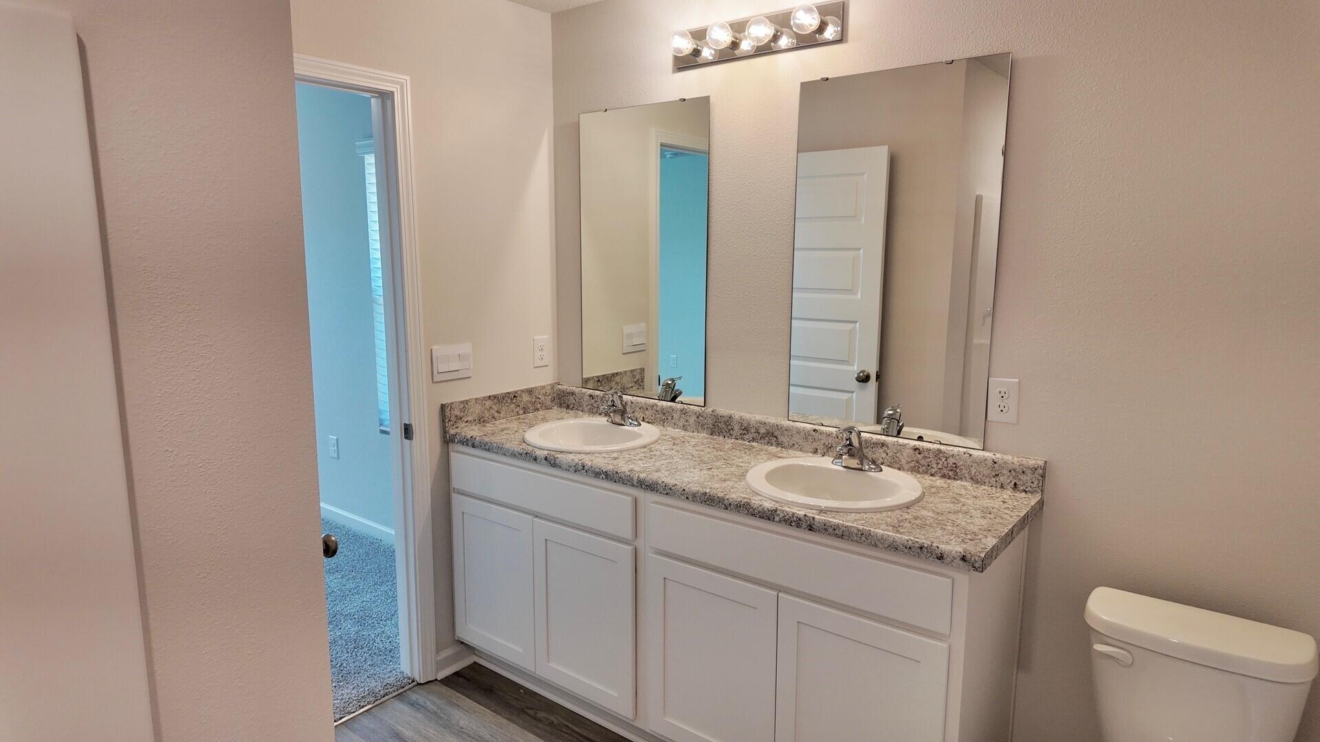 6356 Firefly Drive Milton, FL 32583 - Photo 21 of 44 a bathroom with a granite countertop sink and a mirror