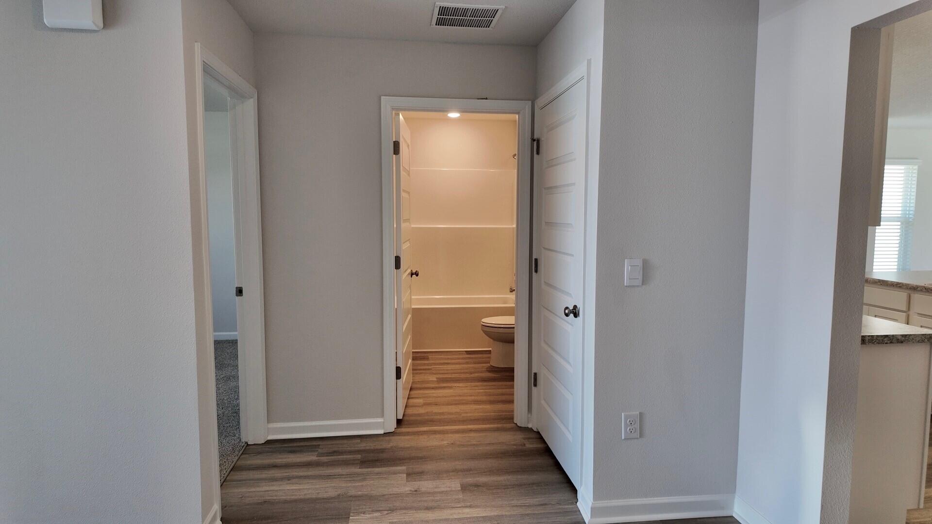 6356 Firefly Drive Milton, FL 32583 - Photo 23 of 44 a view of a hallway with wooden floor