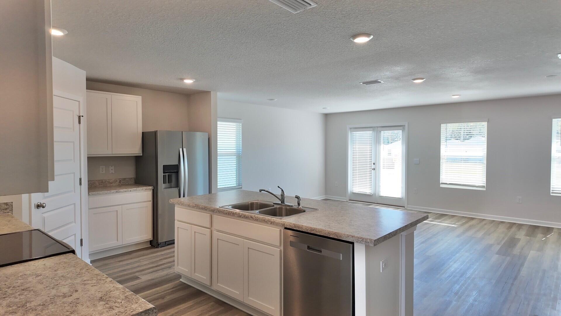 6356 Firefly Drive Milton, FL 32583 - Photo 4 of 44 a kitchen with stainless steel appliances granite countertop a refrigerator and a sink